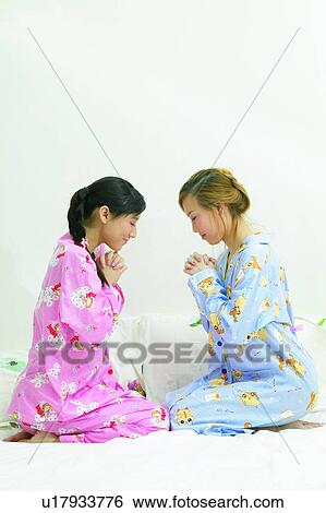 Stock Photograph - Braids, Asian Ethnicity, Black Hair, Bed, Barefoot, Adults Only. Fotosearch
