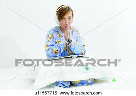 Stock Photography - Individuality, Indoor, Bed, Nightwear, Morning, Kneeling, Headphones. Fotosearch