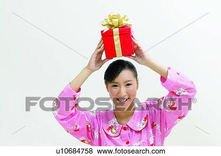 Stock Photo - Indoor, Gift, Lifestyles, Arms Raised, Joy, Bow. Fotosearch