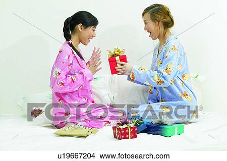 Picture - Smiling, Two People, Friendship, Black Hair, Giving, Lifestyles, Morning Girl. Fotosearch
