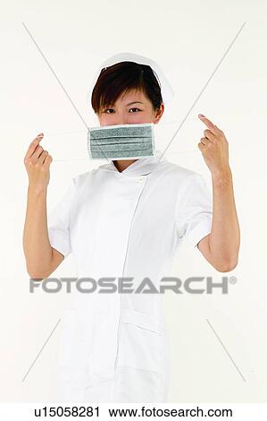 Stock Image - Brown Hair, Female Nurse, Cut Out, Asian Ethnicity. Fotosearch