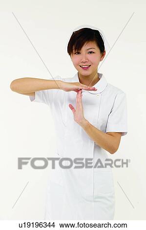 Cut Out, Portrait, Female Nurse, One Person, Time Out Signal, Brown Hair, Asian Ethnicity View Large Photo Image Picture - Cut Out, Portrait, Female Nurse, One Person, Time Out Signal, Brown Hair, Asian Ethnicity. Fotosearch