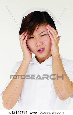 Stock Image - Head In Hands, Close-Up, Cut Out, Brown Hair, Pain, Irritation, Nurse. Fotosearch