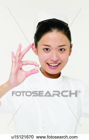 Stock Image - Standing, Asian Ethnicity, Nurse, One Person, Healthcare And Medicine, Holding. Fotosearch