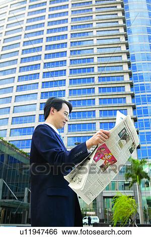 Stock Photograph - Building Exterior, Businessman, Business Suit, Building Structure, Asian Ethnicity. Fotosearch