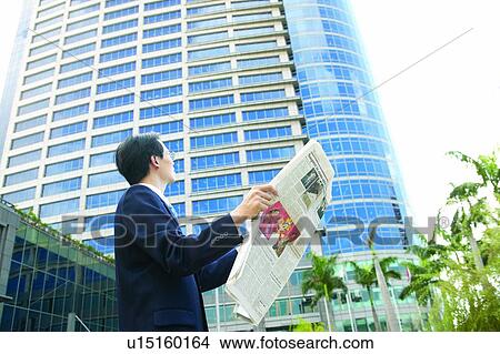Picture - Business, Office Lady, Holding, One Mid Adult Man Only, Formal Clothing, The Media, Standing. Fotosearch