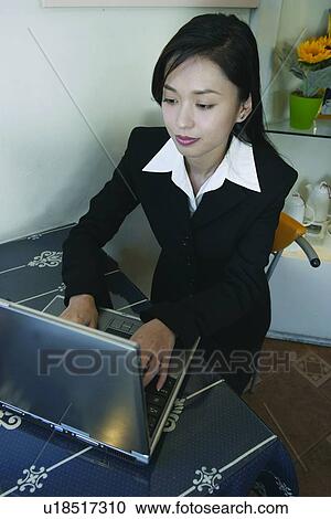 Stock Image - Business Suit, Efficiency, Businesswoman, Asian Ethnicity. Fotosearch