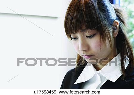 Stock Photo - Business Suit, Long Hair, Focus On Foreground, Asian Ethnicity, Looking Down, Businesswoman. Fotosearch