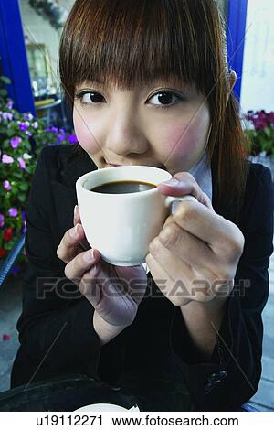 Stock Image - Businesswoman, Bangs, Business Suit, Brown Hair, Beverage, Asian Ethnicity. Fotosearch