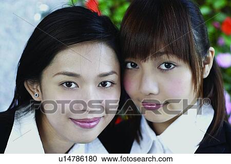 Stock Image - Businesswomen, Asian Ethnicity, Business Suit, Brown Hair, Bangs, Adults Only. Fotosearch