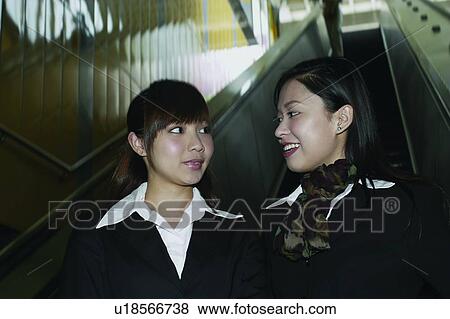 Stock Photo - Businesswomen, Asian Ethnicity, Business Suit, Brown Hair, Bangs, Adults Only. Fotosearch