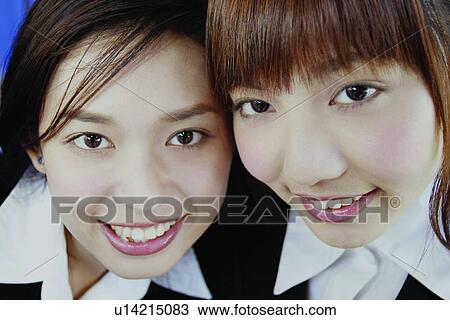 Stock Image - Cheerful, Asian Ethnicity, Businesswomen, Brown Hair, Bangs, Adults Only. Fotosearch