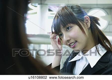 Stock Image - Cheerful, Bangs, Businesswoman, Business Suit, Brown Hair, Asian Ethnicity. Fotosearch
