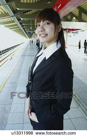 Stock Photo - Cheerful, Bangs, Businesswoman, Business Suit, Brown Hair, Asian Ethnicity. Fotosearch