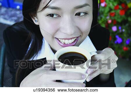 Stock Photograph - Cheerful, Beverage, Cafe, Businesswoman, Business Suit, Asian Ethnicity. Fotosearch
