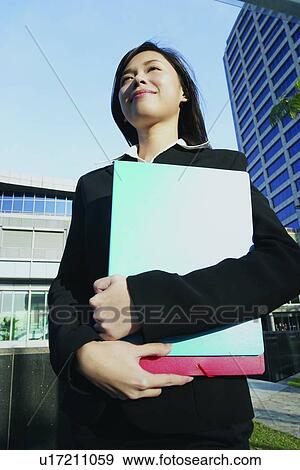 Stock Photo - Clear Sky, Building Exterior, Businesswoman, Business Suit, Building Structure, Asian Ethnicity. Fotosearch