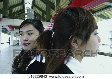 Stock Image - Close-Up, Asian Ethnicity, Businesswomen, Business Suit, Brown Hair, Adults Only. Fotosearch