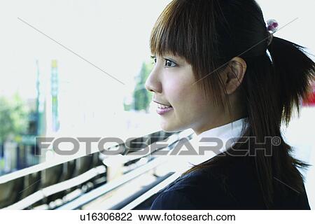 Stock Image - Close-Up, Bangs, Businesswoman, Business Suit, Brown Hair, Asian Ethnicity. Fotosearch