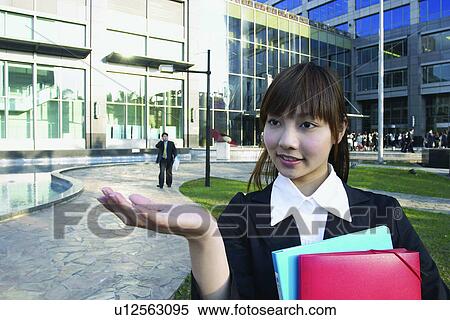 Stock Photography - Close-Up, Bangs, Businesswoman, Business Suit, Brown Hair, Asian Ethnicity. Fotosearch