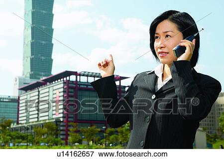 Close-Up, Holding, Business Suit, Standing, Gesturing View Large Photo Image Stock Photo - Close-Up, Holding, Business Suit, Standing, Gesturing. Fotosearch