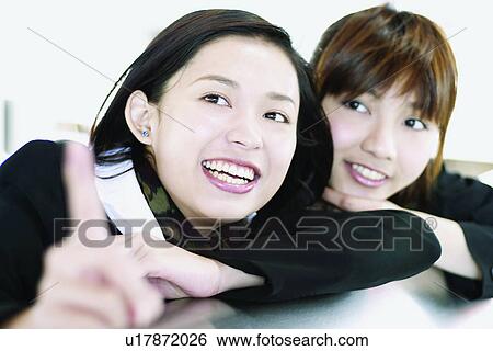 Stock Photograph - Close-Up, Two People, Business, Businesswomen, Asian Ethnicity, Adults Only. Fotosearch