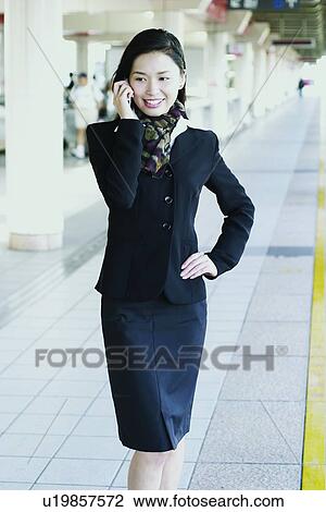 Stock Image - Cravat, Mobility, Railroad Station Platform, Holding, One Young Woman Only, Office. Fotosearch