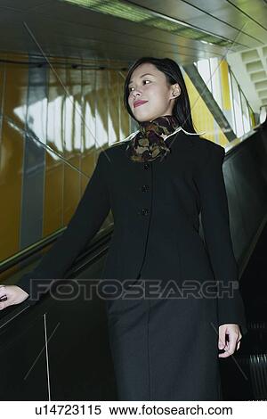 Stock Photography - Holding, Confidence, Long Hair, Escalator. Fotosearch