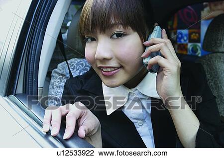 Stock Image - Holding, Head And Shoulders, Success, Talking, Mobile Phone, Bangs, Office. Fotosearch