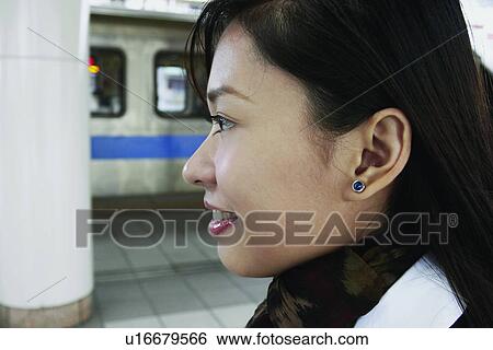 Stock Photograph - Lady, Happiness, One Young Woman Only, Train, Asian Ethnicity. Fotosearch