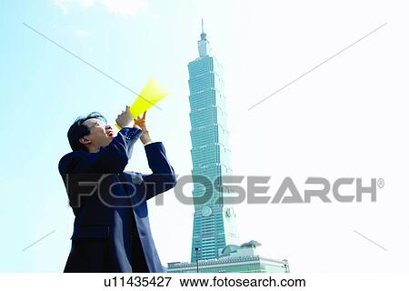 Stock Photo - Megaphone, Business Suit, Outdoor, Building Structure. Fotosearch