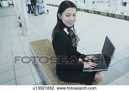 Stock Image - Smiling, Day, Office, Asian Ethnicity, Three-Quarter Length, Lady, Accessibility. Fotosearch