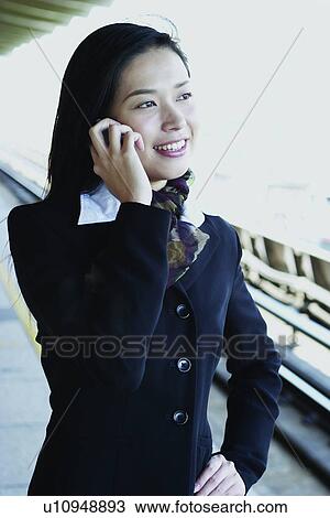 Stock Image - Smiling, Waiting, One Young Woman Only, Young Adult, Lady, Businesswoman. Fotosearch