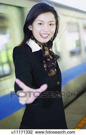 Stock Image - Smiling, Waving, Office, Long Hair, Business Suit. Fotosearch