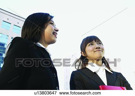 Young Women, Bangs, Business Suit, Toothy Smile, Long Hair, Two People View Large Photo Image Stock Photo - Young Women, Bangs, Business Suit, Toothy Smile, Long Hair, Two People. Fotosearch