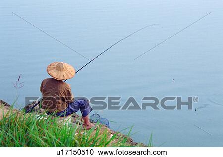 Stock Image - fisherman, fishing, lake, pool, traditional, oriental. Fotosearch