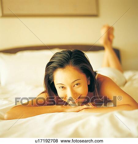 Stock Photo - Black Hair, Asian, Bedroom, Bed, Barefoot, Asian Ethnicity. Fotosearch