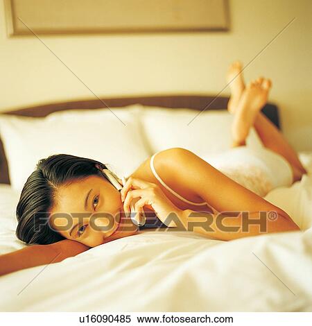 Focus On Foreground, Asian, Bedroom, Bed, Young Adult, Lying On Front View Large Photo Image Stock Photography - Focus On Foreground, Asian, Bedroom, Bed, Young Adult, Lying On Front. Fotosearch