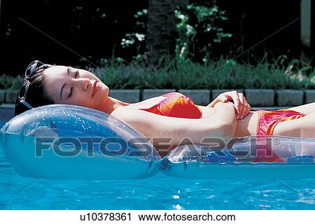 Stock Image - Asian Ethnicity, Black Hair, Bikini, Asian, Arms Crossed. Fotosearch