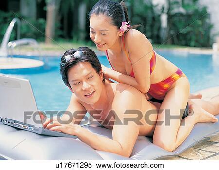 Stock Photography - Kneeling, Looking Away, Asian Ethnicity, Young Men, Lying On Front, Leaning. Fotosearch