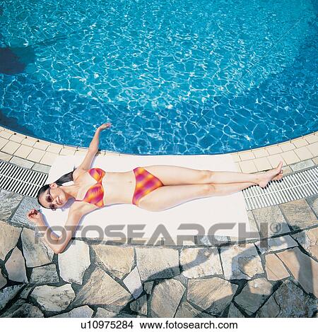 Picture - Outdoor, Vacations, Sunglasses, Towel, Tile, Lying On Back. Fotosearch
