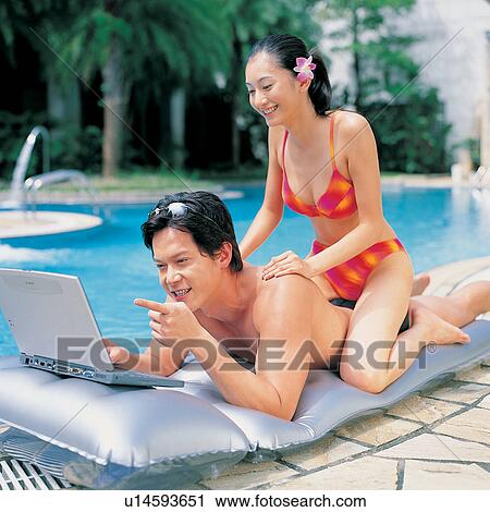 Stock Image - Pointing, Two People, Kneeling, Looking, Romance. Fotosearch