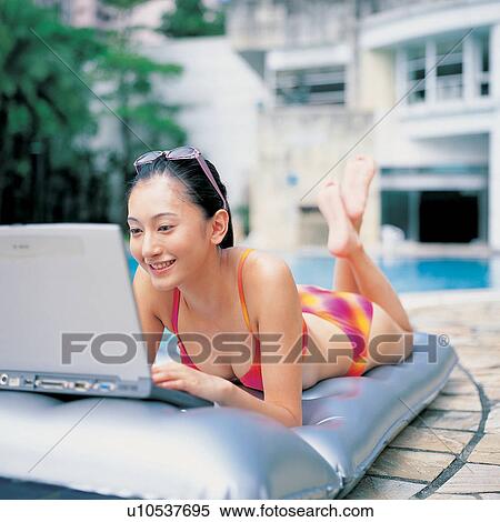 Toothy Smile, Laptop, Swimming Pool, Outdoor, Legs Crossed At Ankle, Vacations View Large Photo Image Stock Photography - Toothy Smile, Laptop, Swimming Pool, Outdoor, Legs Crossed At Ankle, Vacations. Fotosearch