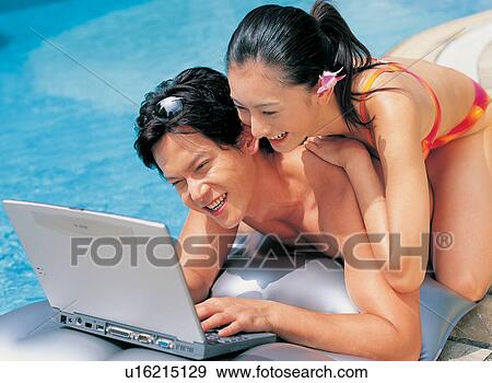Wearing Flower, Three-Quarter Length, Swimming Pool, Two People, Young Adult, Looking View Large Photo Image Stock Photo - Wearing Flower, Three-Quarter Length, Swimming Pool, Two People, Young Adult, Looking. Fotosearch