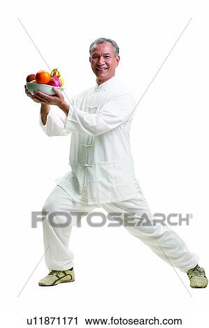 Stock Image - Citrus Fruit, Apple, Casual Clothing, Bending, Asian Ethnicity, Active. Fotosearch