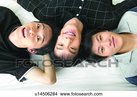 Picture - Casual Clothing, Adolescence, Black Hair, Bed, Asian Ethnicity, Close-Up, 16-17 Years. Fotosearch