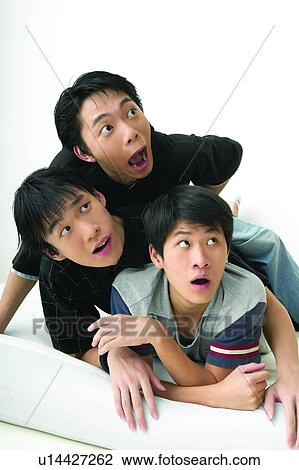 Stock Image - Casual Clothing, Adolescence, Black Hair, Bed, Asian Ethnicity, Close-Up, 16-17 Years. Fotosearch