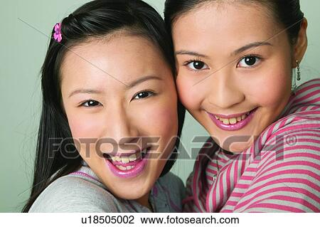 Stock Image - Casual Clothing, Adolescence, Black Hair, Asian Ethnicity, Arm Around, Close-Up, 16-17 Years. Fotosearch