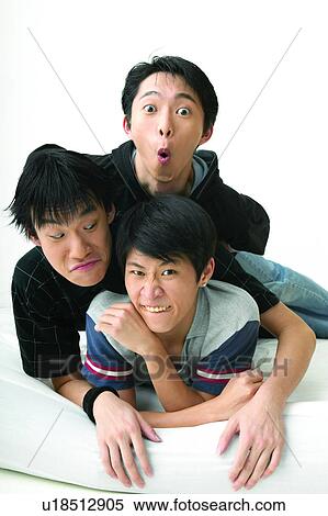Stock Photography - Casual Clothing, Adolescence, Black Hair, Bed, Asian Ethnicity, Clenching Teeth, 16-17 Years. Fotosearch
