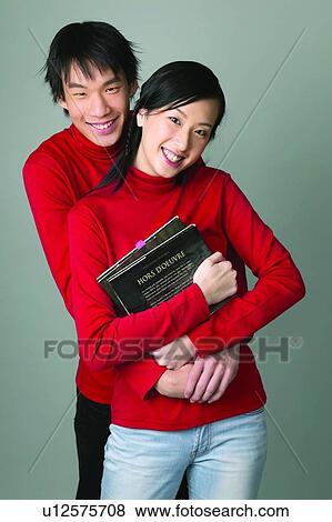 Stock Photo - Casual Clothing, Adolescence, Book, Black Hair, Asian Ethnicity, Close-Up, 16-17 Years. Fotosearch