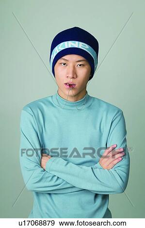 Stock Photo - Casual Clothing, Colored Background, One Teenage Boy Only, Indoor, Attitude, Asian. Fotosearch